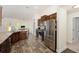 Modern kitchen with stainless steel appliances, dark wood cabinetry, and breakfast area at 9562 Sw 45Th Ave, Ocala, FL 34476