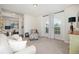 Cozy living area with plush seating, a large window, neutral carpet, and tasteful accents at 9562 Sw 45Th Ave, Ocala, FL 34476