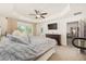 Large main bedroom featuring tray ceiling, ceiling fan, and exterior door at 9562 Sw 45Th Ave, Ocala, FL 34476