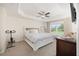 Spacious main bedroom featuring tray ceiling, ceiling fan, and a large window at 9562 Sw 45Th Ave, Ocala, FL 34476