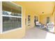 Covered patio with outdoor seating, showcasing a relaxing space for entertaining or enjoying the backyard view at 9562 Sw 45Th Ave, Ocala, FL 34476