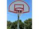 A red-and-white basketball hoop in a community park, set against a clear blue sky at 9706 Sw 92Nd Place Rd, Ocala, FL 34481