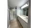 Well-lit bathroom featuring dual sinks, a large shower, and updated fixtures at 9706 Sw 92Nd Place Rd, Ocala, FL 34481