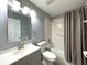 Bathroom with sink, toilet, mirror, and tiled shower at 9706 Sw 92Nd Place Rd, Ocala, FL 34481