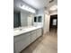 Bathroom featuring dual sinks, and large mirrors, perfect for modern living at 9706 Sw 92Nd Place Rd, Ocala, FL 34481