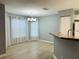 Open dining area with laminate floors, bright windows with curtains, and a stylish light fixture at 9706 Sw 92Nd Place Rd, Ocala, FL 34481