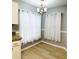 Cozy dining area with laminate flooring, natural light, and modern chandelier at 9706 Sw 92Nd Place Rd, Ocala, FL 34481