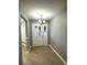 Welcoming entryway featuring a modern chandelier and a front door with decorative glass panels and grey walls at 9706 Sw 92Nd Place Rd, Ocala, FL 34481