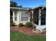 Charming exterior featuring a well-maintained yard, mature trees, and a screened-in lanai, creating a serene outdoor space at 9706 Sw 92Nd Place Rd, Ocala, FL 34481