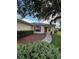 Inviting single-story home with a cozy front porch, brick pathway, and lush landscaping at 9706 Sw 92Nd Place Rd, Ocala, FL 34481