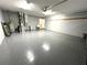 Spacious garage featuring epoxy flooring, a utility sink, and ample storage, perfect for a workshop or parking at 9706 Sw 92Nd Place Rd, Ocala, FL 34481