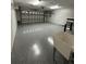 Well-lit garage with epoxy flooring, a utility sink, and an automatic door opener for convenience at 9706 Sw 92Nd Place Rd, Ocala, FL 34481