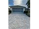 Spacious two-car garage with brick-paved driveway, offering convenience and curb appeal at 9706 Sw 92Nd Place Rd, Ocala, FL 34481