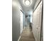 Hallway featuring plank flooring, lots of storage, and access to the bathroom at 9706 Sw 92Nd Place Rd, Ocala, FL 34481