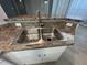 Close-up of a stainless steel double sink with modern faucet and durable laminate countertop at 9706 Sw 92Nd Place Rd, Ocala, FL 34481
