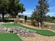 Miniature putting green area with nice landscaping in the community with cart path visible at 9706 Sw 92Nd Place Rd, Ocala, FL 34481