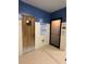 Entrance to the spa with wooden door on the left and glass door on the right at 9706 Sw 92Nd Place Rd, Ocala, FL 34481