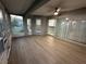 Spacious sunroom with wood-look flooring, multiple windows, and sliding doors, perfect for entertaining at 9706 Sw 92Nd Place Rd, Ocala, FL 34481