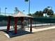 Relaxing gazebo at the tennis court, offering a shaded seating area and views of the games at 9706 Sw 92Nd Place Rd, Ocala, FL 34481