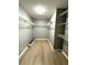 Large walk-in closet with ample shelving and wood flooring at 9706 Sw 92Nd Place Rd, Ocala, FL 34481
