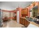 Functional kitchen featuring wood cabinets and an eat-in dining area at 9710 Sw 96Th St, Ocala, FL 34481