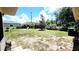 Expansive backyard with mature trees and sunny lawn, framed by home on either side at 16905 Sw 30Th Avenue Rd, Ocala, FL 34473