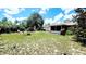Beautiful backyard with green grass, a patio, mature trees, and a screened-in porch, perfect for outdoor entertaining at 16905 Sw 30Th Avenue Rd, Ocala, FL 34473