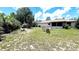 A spacious backyard featuring lush greenery and a charming patio area for outdoor enjoyment at 16905 Sw 30Th Avenue Rd, Ocala, FL 34473