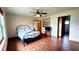 Comfortable bedroom with wood flooring, a ceiling fan, and lots of natural light at 16905 Sw 30Th Avenue Rd, Ocala, FL 34473