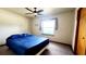 Simple bedroom with a ceiling fan and a sunny window at 16905 Sw 30Th Avenue Rd, Ocala, FL 34473