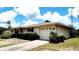 This home features an attached garage and a well-manicured lawn that enhances the property's curb appeal at 16905 Sw 30Th Avenue Rd, Ocala, FL 34473