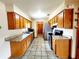 Functional kitchen includes sleek granite countertops, stainless steel appliances, and ample wooden cabinet space at 16905 Sw 30Th Avenue Rd, Ocala, FL 34473