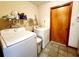 Bright laundry room with washer, dryer, and built-in shelving for storage at 16905 Sw 30Th Avenue Rd, Ocala, FL 34473