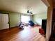 Cozy living area with hardwood floors, a large window, and a ceiling fan for year-round comfort at 16905 Sw 30Th Avenue Rd, Ocala, FL 34473