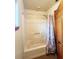 Standard bathtub and shower combination with shower curtain and safety bar at 16905 Sw 30Th Avenue Rd, Ocala, FL 34473