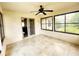 The sunroom boasts black framed windows and neutral tiled flooring, accessible to kitchen at 16905 Sw 30Th Avenue Rd, Ocala, FL 34473