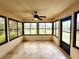 The sunroom boasts black framed windows and neutral tiled flooring at 16905 Sw 30Th Avenue Rd, Ocala, FL 34473