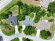 Aerial view showcases this home with surrounding homes, lush greenery, and a quiet neighborhood street at 10130 Sw 61St Terrace Rd, Ocala, FL 34476