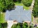 Birds-eye view of a home with a gray roof, surrounded by lush greenery and mature trees at 10130 Sw 61St Terrace Rd, Ocala, FL 34476