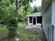 Backyard view with chain link fencing, screened lanai, and plenty of space for outdoor activities at 10130 Sw 61St Terrace Rd, Ocala, FL 34476