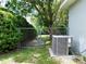 View of the backyard with a chain link fence and gate leading to a wooded area and an AC unit at 10130 Sw 61St Terrace Rd, Ocala, FL 34476