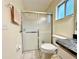 Bathroom featuring a glass enclosed shower, toilet, and single sink vanity with grey countertops at 10130 Sw 61St Terrace Rd, Ocala, FL 34476