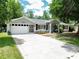 Charming single-story home with a well-manicured lawn, driveway, and two-car garage at 10130 Sw 61St Terrace Rd, Ocala, FL 34476