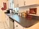 Well-lit kitchen with white cabinetry, a stainless steel sink, and modern appliances creates a warm and inviting space at 10130 Sw 61St Terrace Rd, Ocala, FL 34476