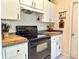 Kitchen with white cabinets and black appliances at 10130 Sw 61St Terrace Rd, Ocala, FL 34476