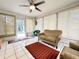 Bright sunroom with tile floors, ceiling fan, and lots of natural light from the many windows at 10130 Sw 61St Terrace Rd, Ocala, FL 34476