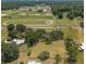Aerial view of home and land, with racetrack and school in the background at 10600 Se 32Nd Ave, Ocala, FL 34480
