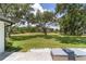 Expansive backyard featuring lush lawn space with a large tree, and a patio area for outdoor seating and entertaining at 10600 Se 32Nd Ave, Ocala, FL 34480