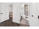 Bright bathroom featuring a walk-in shower, modern fixtures and dark wood-look floors at 10600 Se 32Nd Ave, Ocala, FL 34480