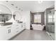 Modern bathroom featuring dual sinks, a freestanding tub, and glass walk-in shower at 10600 Se 32Nd Ave, Ocala, FL 34480